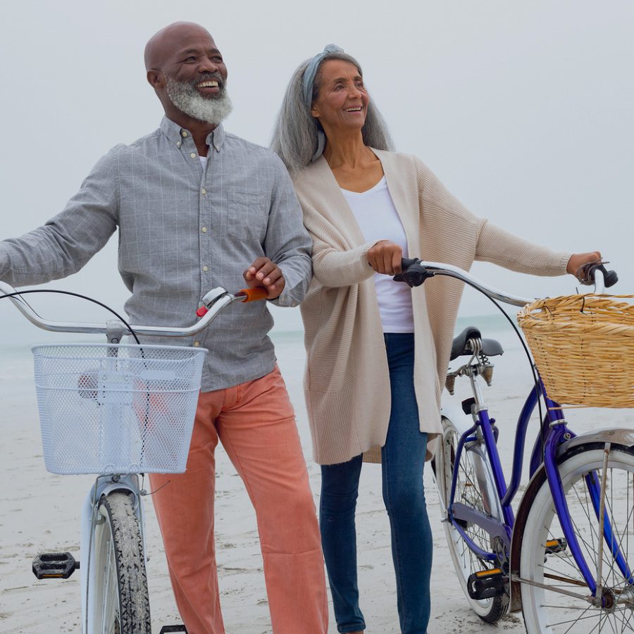 Man and woman with bicycles, representing Zing Health.