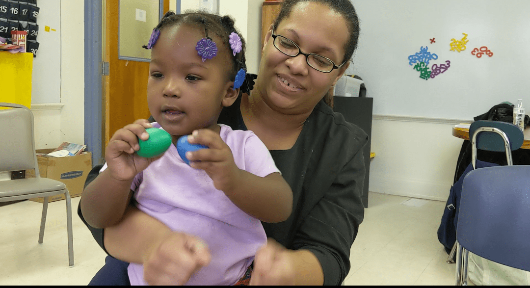 Woman embraces child.