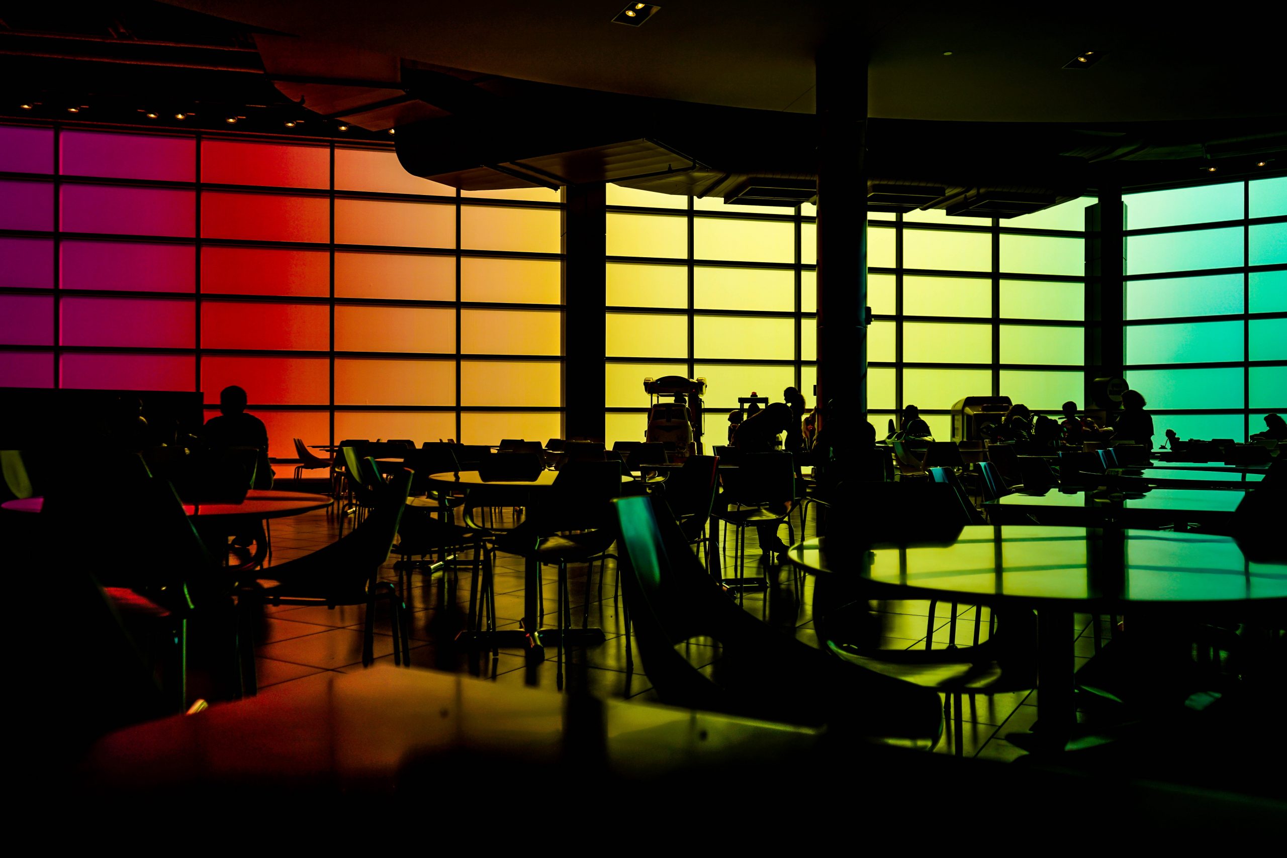 Round black table with chairs in silhouette.