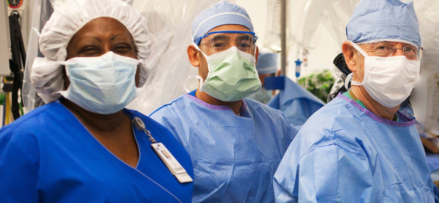 Medical workers in surgical masks and gowns.