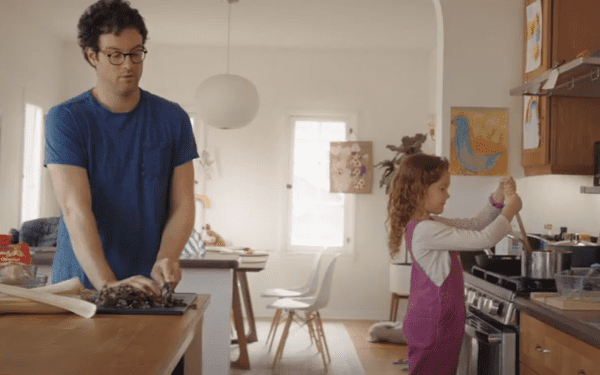 Man and girl in kitchen.
