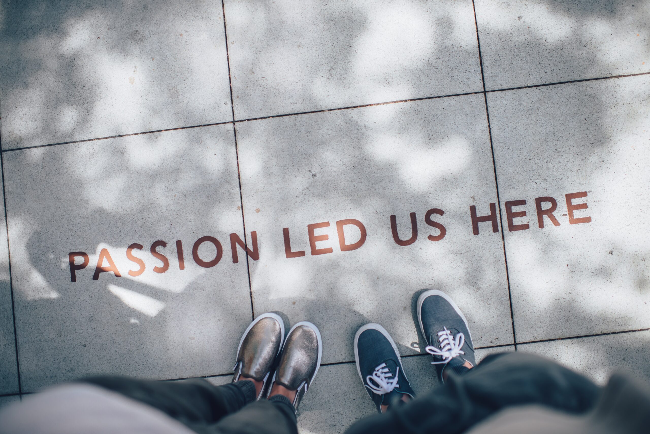 Text on Pavement: Passion Led Us Here.