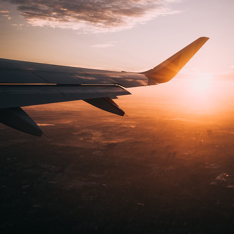 Airplane above clouds at sunrise, representing AAR.