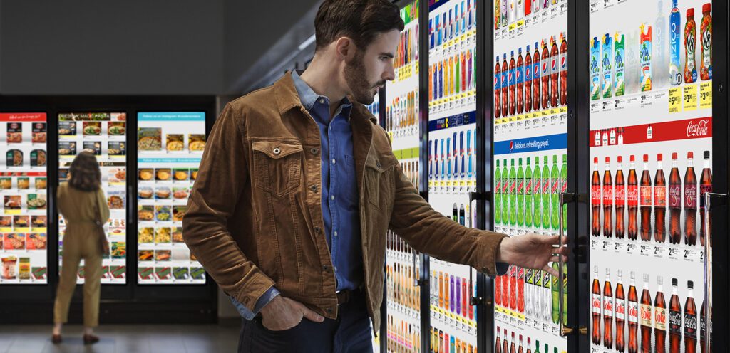 Man at Cooler Screens refrigerator display.