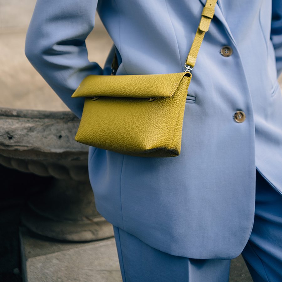 Purse slung over hip representing Luxury Garage Sale.