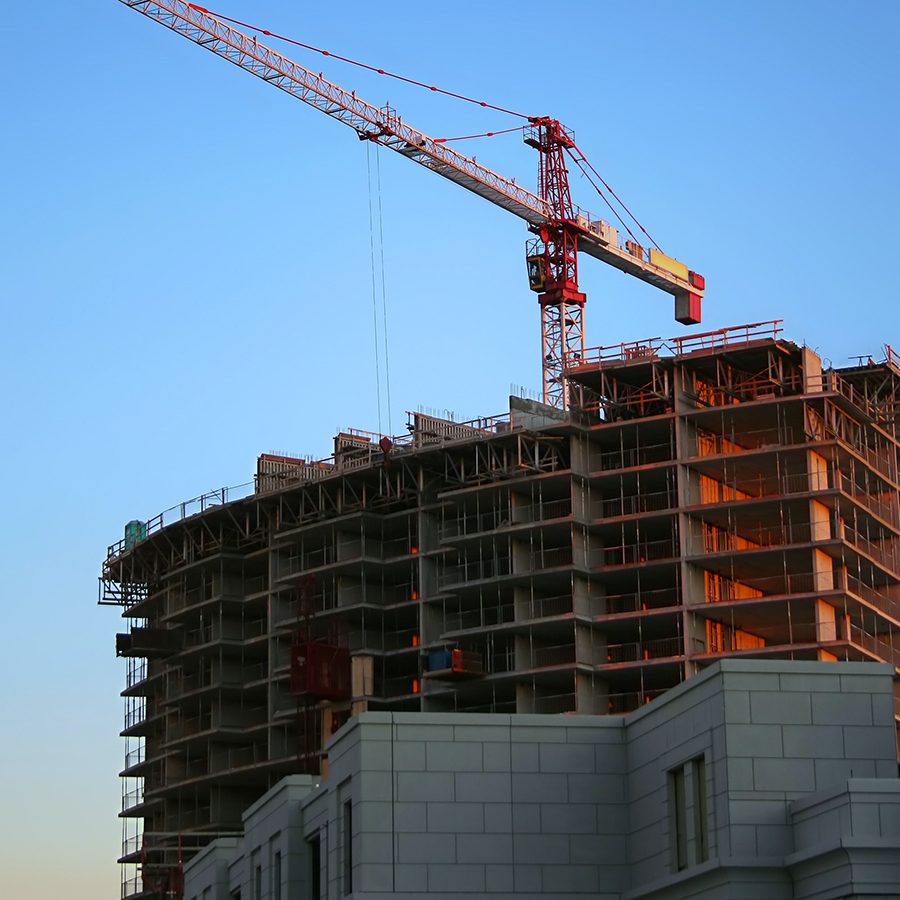 Construction crane and high-rise representing Procore Technologies.