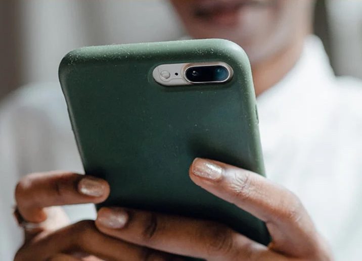 Mobile phone in hand.