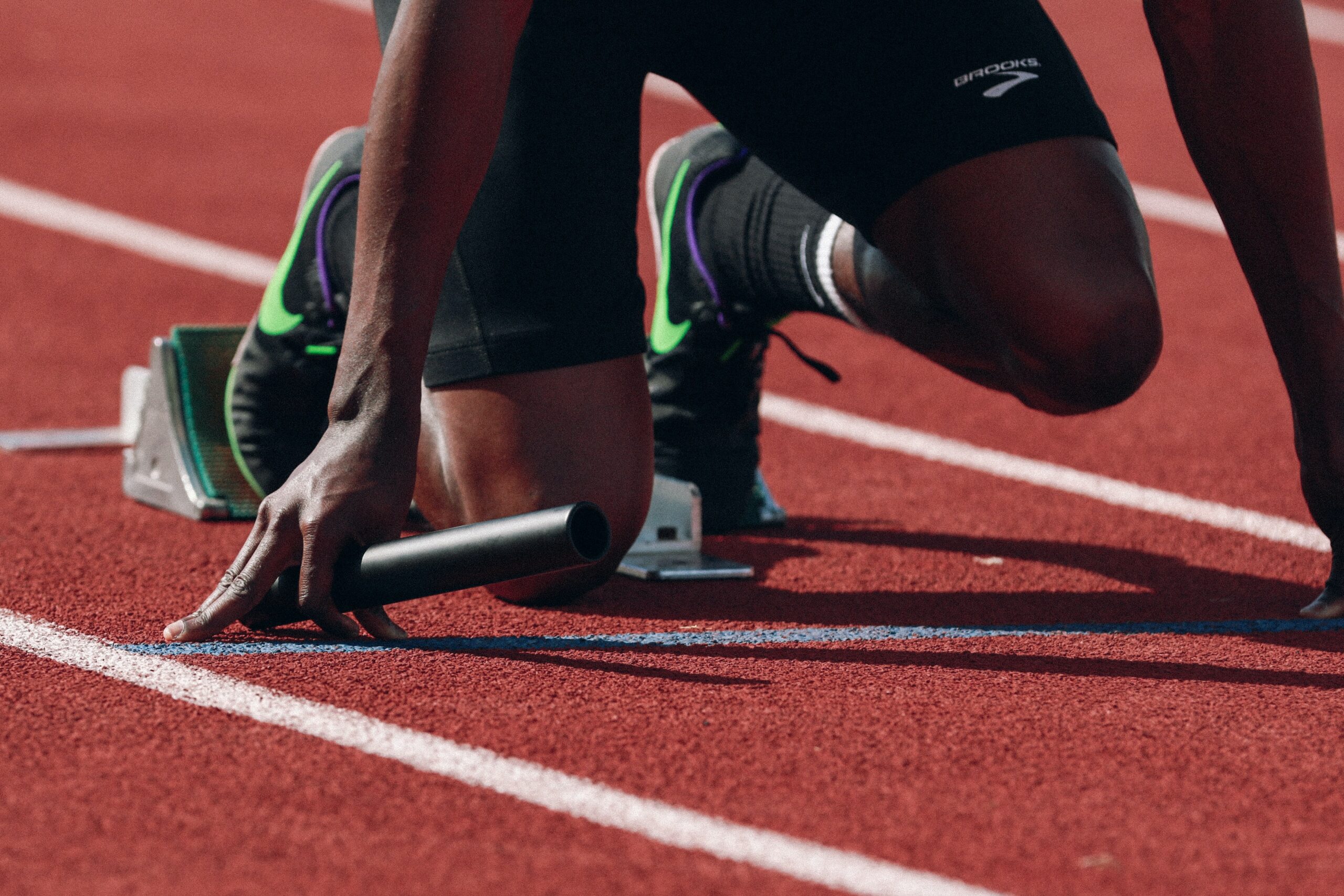 Man at starting line of running track.