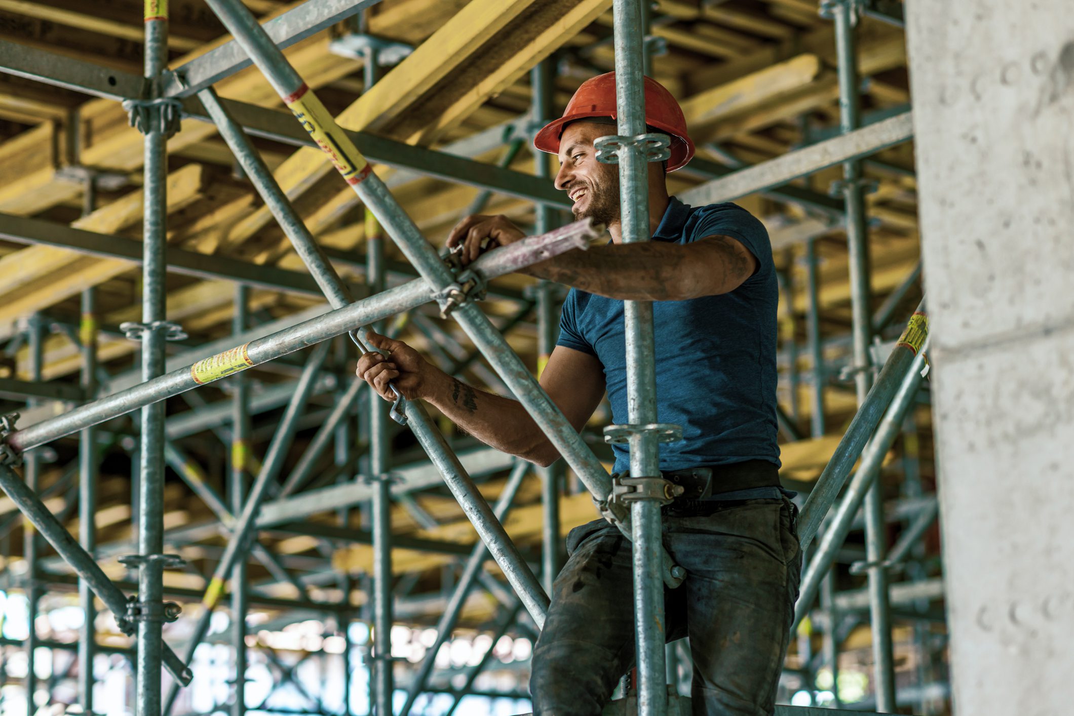 Bricklayer on construction scaffold.